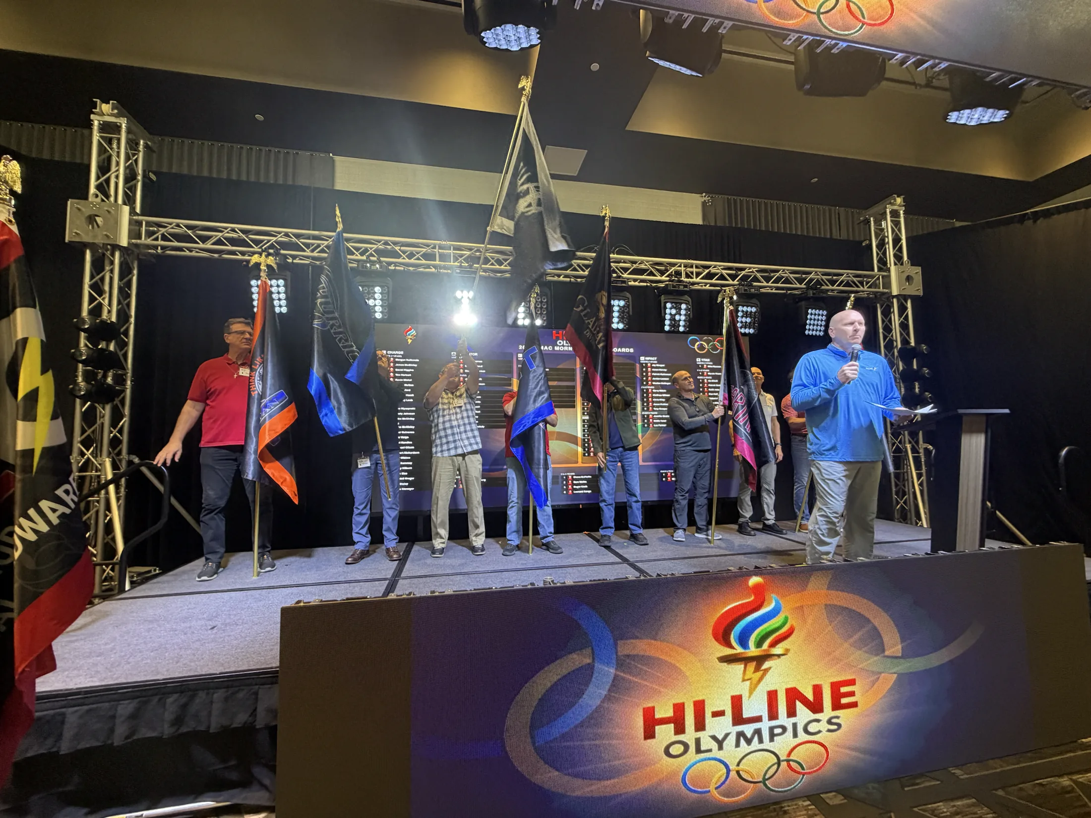 Team captains and flags on the Hi-Line Olympics stage