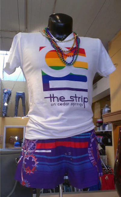 A rainbow version of the mark printed on a t-shirt displayed in a shop window