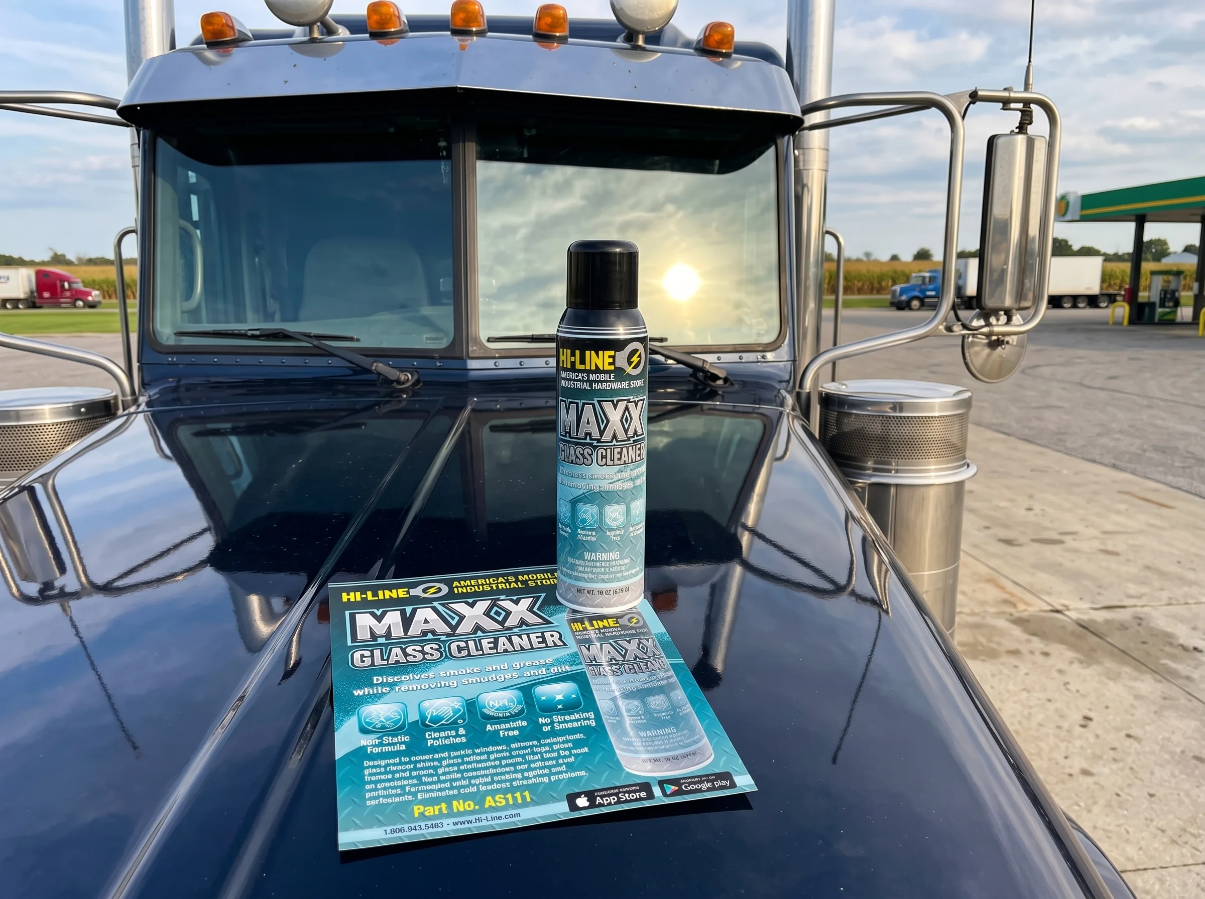 A MAXX glass cleaner can and sell sheet on the hood of a semi truck at a truck stop